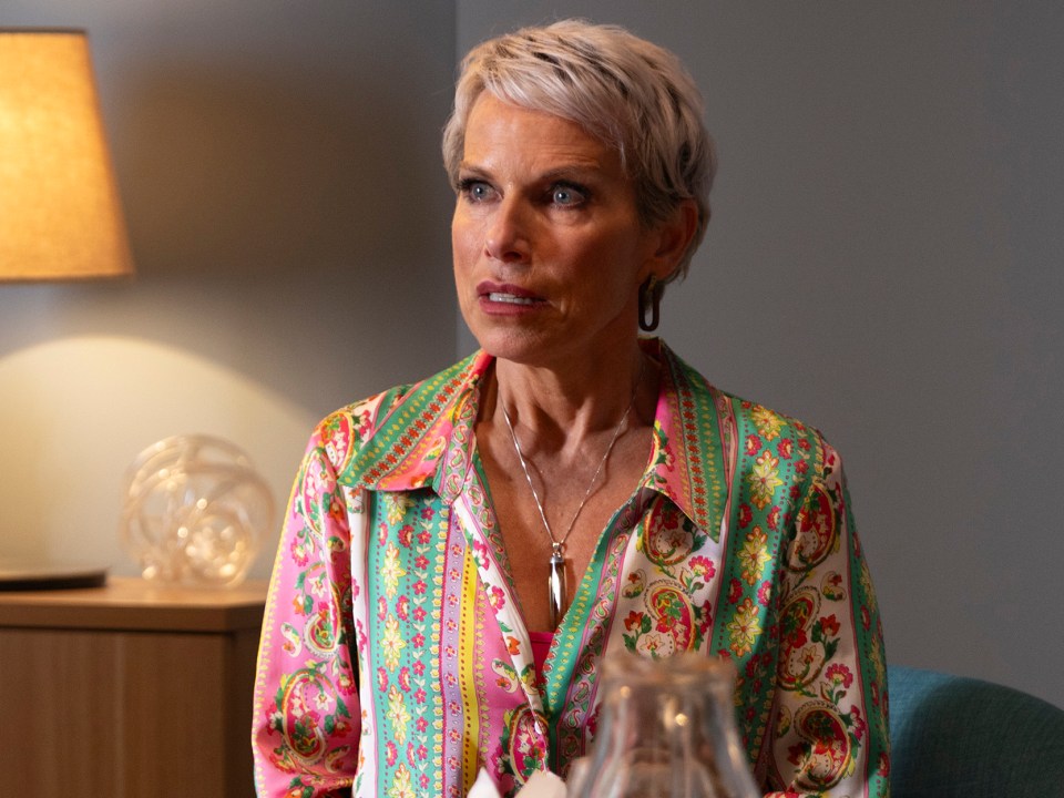 Coronation Street's Debbie Webster looking shocked and concerned as she sits in a doctor's office.