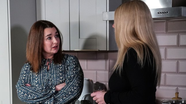 Vicki Fowler and Sharon Watts talking in the kitchen in EastEnders.