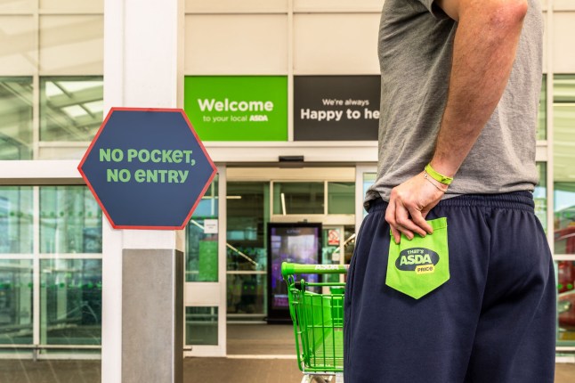 A man holding a fake back pocket outside Asda