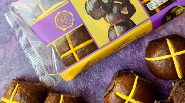 A packet of M&S new Dippy Egg Hot Cross Buns with a purple background