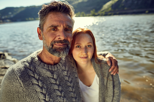 Portrait of father and adult daughter at the riverside