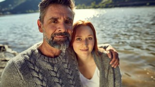 Portrait of father and adult daughter at the riverside