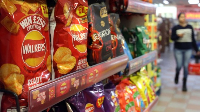 Packets of Walkers crisps are display for sale inside a store in the UK