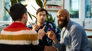 Multi ethnic group sharing ideas in office