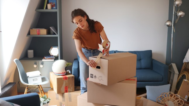 A young woman packing her moving boxes.