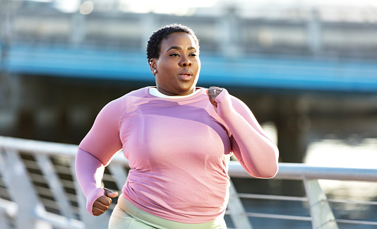 African-American woman with large build, running in city