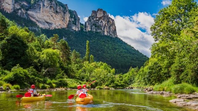 Kayakers paddle down the River Tarn in Rabastens, south of France on a sunny day