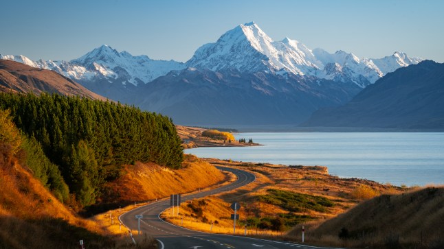 A mountain topped with snow beside a lake in New Zealand
