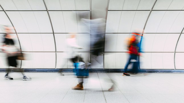 Blurred commuters rushing on the London Tube.