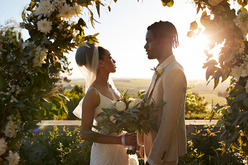 Young bride and groom standing at wedding altar