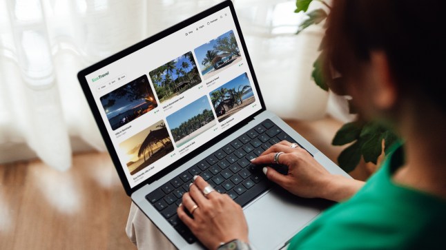 Young woman planning a sustainable travel with laptop
