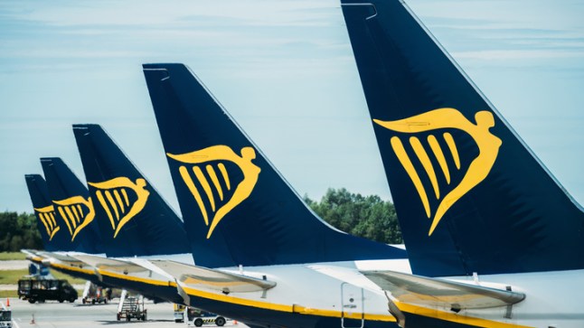 The tailfinds of several Ryanair planes, featuring a yellow icon on a navy blue background.