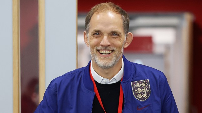 England manager Thomas Tuchel smiling, wearing a blue Three Lions jacket on his first day.