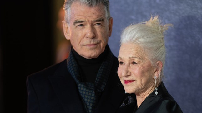 Dame Helen Mirren and Pierce Brosnan posing on the red carpet wearing black.