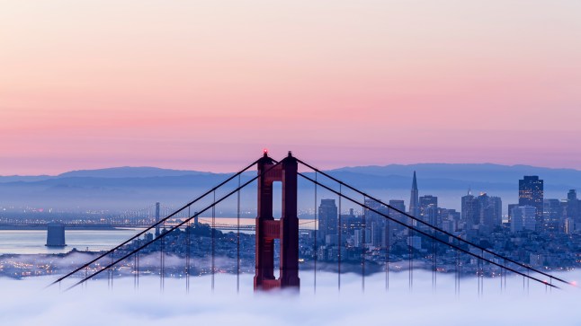 The Golden Gate Bridge shrouded in mist at sunset, in San Francisco