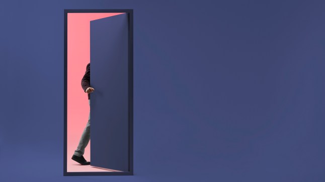Man walking threw doorway in futuristic room