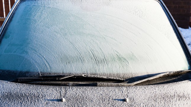 Frosty patterns on a completely covered car windscreen
