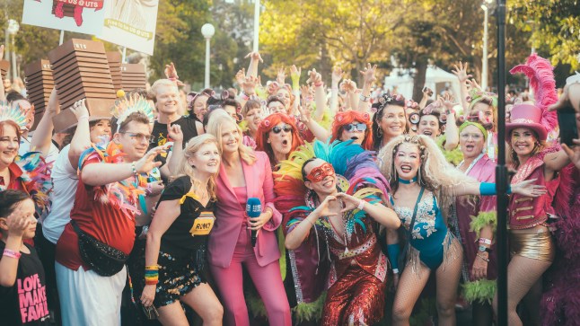 A group of people in colourful costumes celebrating Mardi Gras on the streets of Sydney, Australia