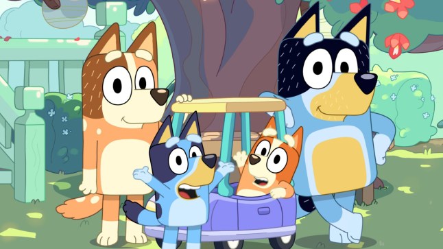 Chilli, Bandit, Bluey, and Bingo posing outside in front of a tree in Bluey