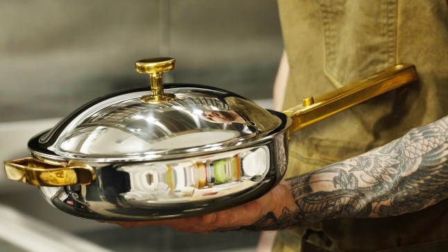 New Titanium Pro Cookware Set by Our Place in someone's hands - possibly serving dinner