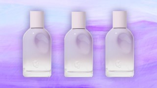 Three bottles of Glossier You Fleur on a purple background.