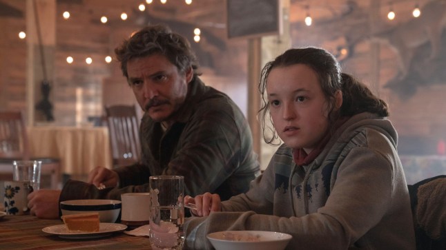 Pedro Pascal and Bella Ramsey in a diner in a scene from The Last of Us.