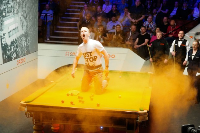 File photo dated 17-04-2023 of 'Just Stop Oil' protesters forcing a stoppage in play early in the evening session at the World Snooker Championship in Sheffield. A man interrupted the match between Robert Milkins and Joe Perry by jumping on the table where he released a packet of orange dye. Issue date: Thursday November 14, 2023. PA Photo. See PA story SPORT Christmas April. Photo credit should read Mike Egerton/PA Wire.