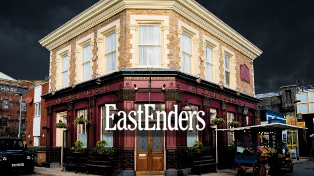 The Queen Vic at night in EastEnders with the logo in the centre.