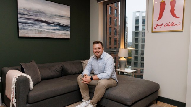 What I Own - Adam Howie of 404 Pioneer House, 3 New Acres Road, London SW18 1UZ Pictured: Adam on his sofa in the living room Shot on 8th November 2024. (C) Belinda Jiao 07598931257 www.belindajiao.com jiao.bilin@gmail.com