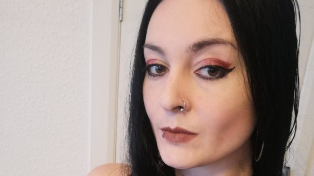 Jules Black looking into the camera, wearing dark eye make-up