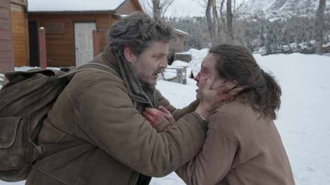 Joel grasping Ellie's face in a snowy woodland, in the TV series The Last Of Us.