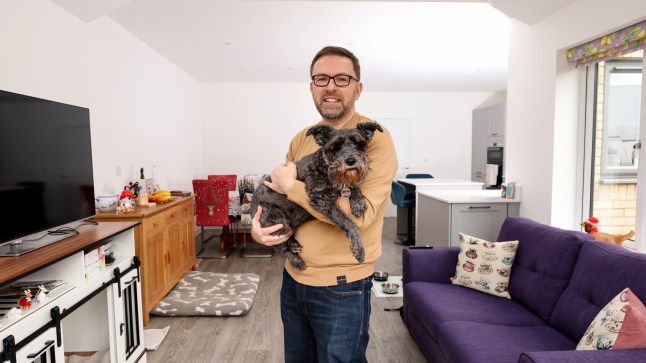 Richard Tosh with his dog liquorice at his home in St Neots Cambridgeshire. Richard and his family have recently bought the four bedroom property after returning to the UK from New Zealand.
