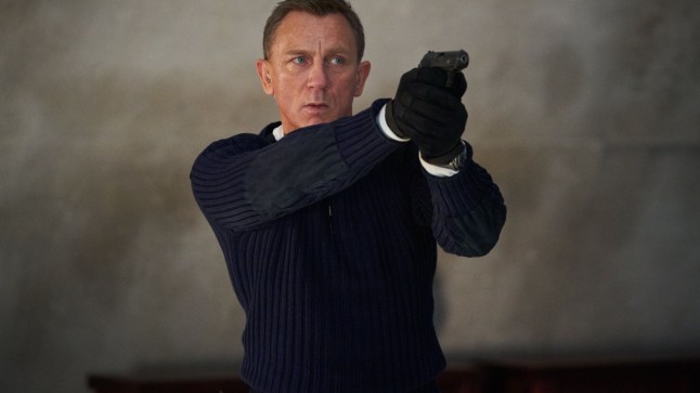 Daniel Craig as James Bond holding gun