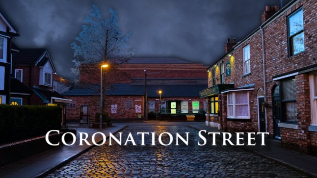 Coronation Street logo over the street at night