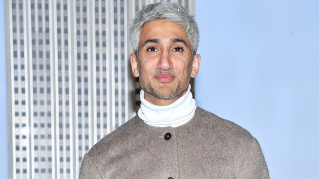 Tan France in a white jumper and grey jacket
