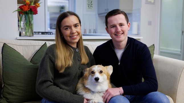 Emily McAllister and Ciaran Dennis are pictured with their corgi, Padron, in the living room of their Upminster maisonette.
