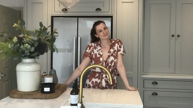 Kat Sanders stands in the kitchen of her Victorian barn conversion.