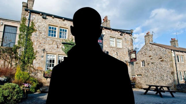 A silhouette of Joe Tate in front of the Woolpack pub in Emmerdale.