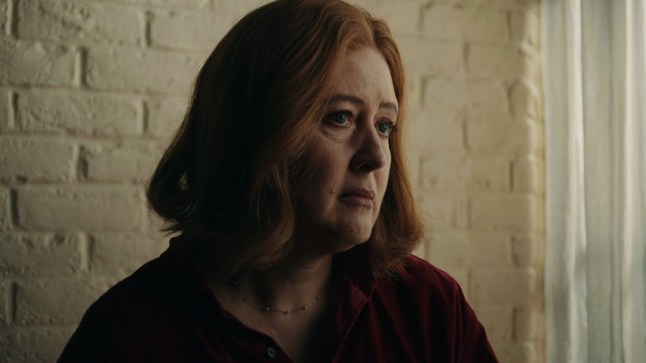 Naomi in The Undercover Police Scandal: Love and Lies on ITV. She is in a dark room and looking down