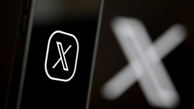 (FILES) This illustration photograph shows the logo of social network X (formerly Twitter) displayed on a smartphone in Brussels on September 27, 2024. Elon Musk said X was hit by a "massive" cyberattack on March 10, 2025, as outages plagued users of the platform once known as Twitter. Musk blamed a cyberattack, providing no evidence, for crashing the site last year when an interview with Donald Trump was to be streamed. (Photo by Nicolas TUCAT / AFP) (Photo by NICOLAS TUCAT/AFP via Getty Images)