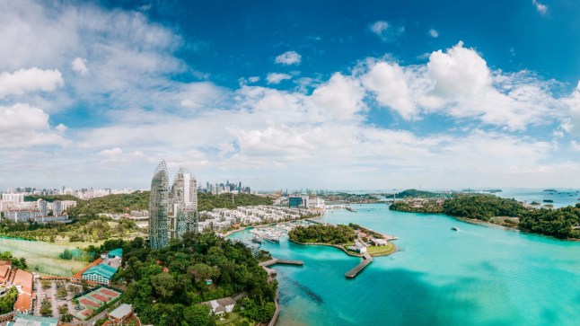Panorama overlooking the southern part of Singapore, including the adventure island of Sentosa to the right and the luxurious homes of Keppel Bay to the left.