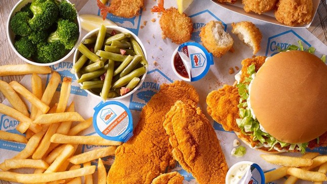 A spread of food from fast food chain Captain D's including a fish sandwich, green beans, battered fish and chips