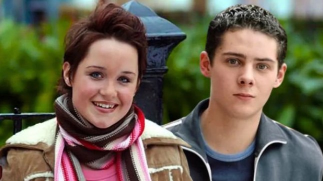 Vicki Fowler and Spencer Moon in front of the Albert Square sign in EastEnders.