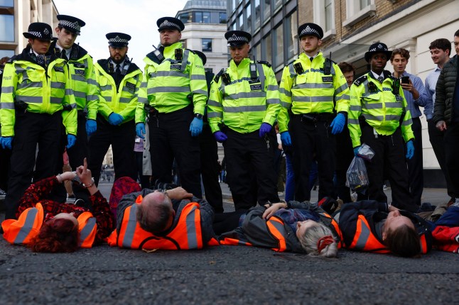 (FILE PHOTO) Supporters of the climate group Just Stop Oil UK have announced after three years of protests, they are ending their campaign of civil resistance with until a final protest in Parliament Square on 26 April,2025. LONDON, ENGLAND - OCTOBER 27: 'Just Stop Oil' protesters are arrested after they blocked the road at the junction of Cannon St and Queen Victoria St on October 27, 2022 in London, England. The environmental activist group has staged a series of guerrilla protests in London in recent weeks. (Photo by Jeff J Mitchell/Getty Images)
