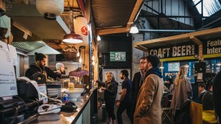 London, UK - January 13, 2019: People at Hermanos Taco House stand in Mercato Metropolitano, sustainable community market in London focused on revitalising the area and protecting environment.