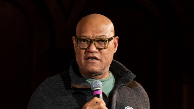 Laurence Fishburne wearing a casual look on stage with a microphone