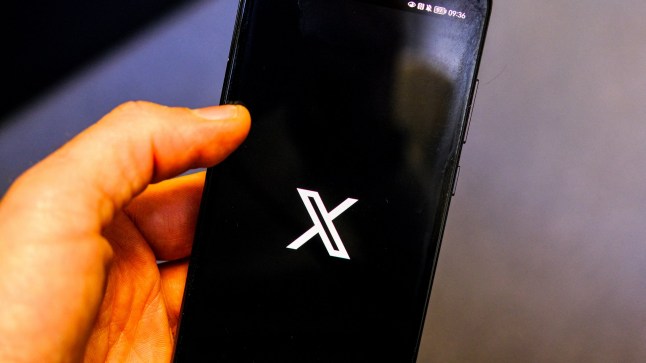 Illustration of the finger of an Internet user who is looking and preparing to open the X application (exTwitter) on his smartphone, in Valence, France, January 16, 2025. (Photo by Nicolas Guyonnet / Hans Lucas / Hans Lucas via AFP) (Photo by NICOLAS GUYONNET/Hans Lucas/AFP via Getty Images)