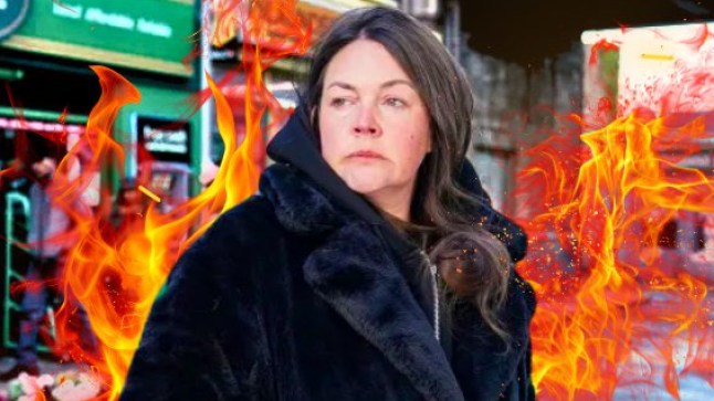 EastEnders character Stacey Slater stood on Bridge Street, surrounded by flames.