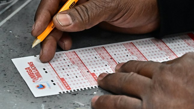 A selection of numbers are picked for the Mega Millions lottery at a liquor store where winning tickets have been sold on December 27, 2024 in Hawthorne, California. The ninth-largest lottery jackpot in US history worth $1.15 billion will be drawn tonight in the Mega Millions drawing, after no tickets with all six numbers have been sold in 30 consecutive drawings. (Photo by Frederic J. BROWN / AFP) (Photo by FREDERIC J. BROWN/AFP via Getty Images)