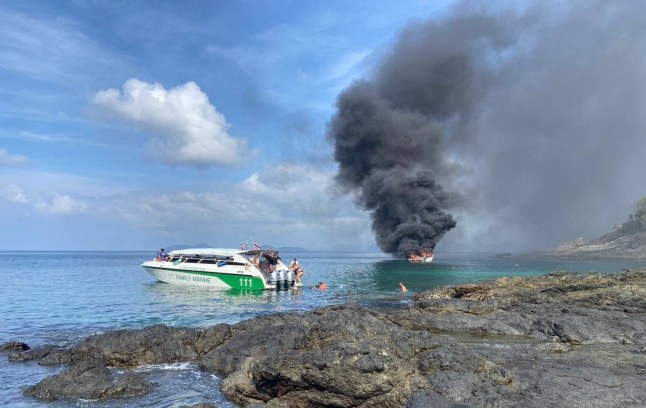 Dozens of tourists swam for their lives to escape a burning speedboat off the coast of Thailand this morning. The 33 holidaymakers and four Thai crew were sailing on the vessel, Tana Marine 555, from Phuket to Koh Mai Thon when it caught fire 50ft from the shore. They jumped overboard to escape the roaring flames and were rescued by a passing boat. Footage shows black smoke plumes billowing from the speedboat lodged between rocks as it was engulfed in flames. Nachapong Pranit, director of the Phuket Marine Office, said authorities deployed a rescue team after receiving a report at 9:20 am. Emergency responders arrived and found the passengers watching the wreckage burn from a distance. All 37 onboard the boat were taken to a hospital for treatment in Phuket. PACKAGE: Video, pictures, text